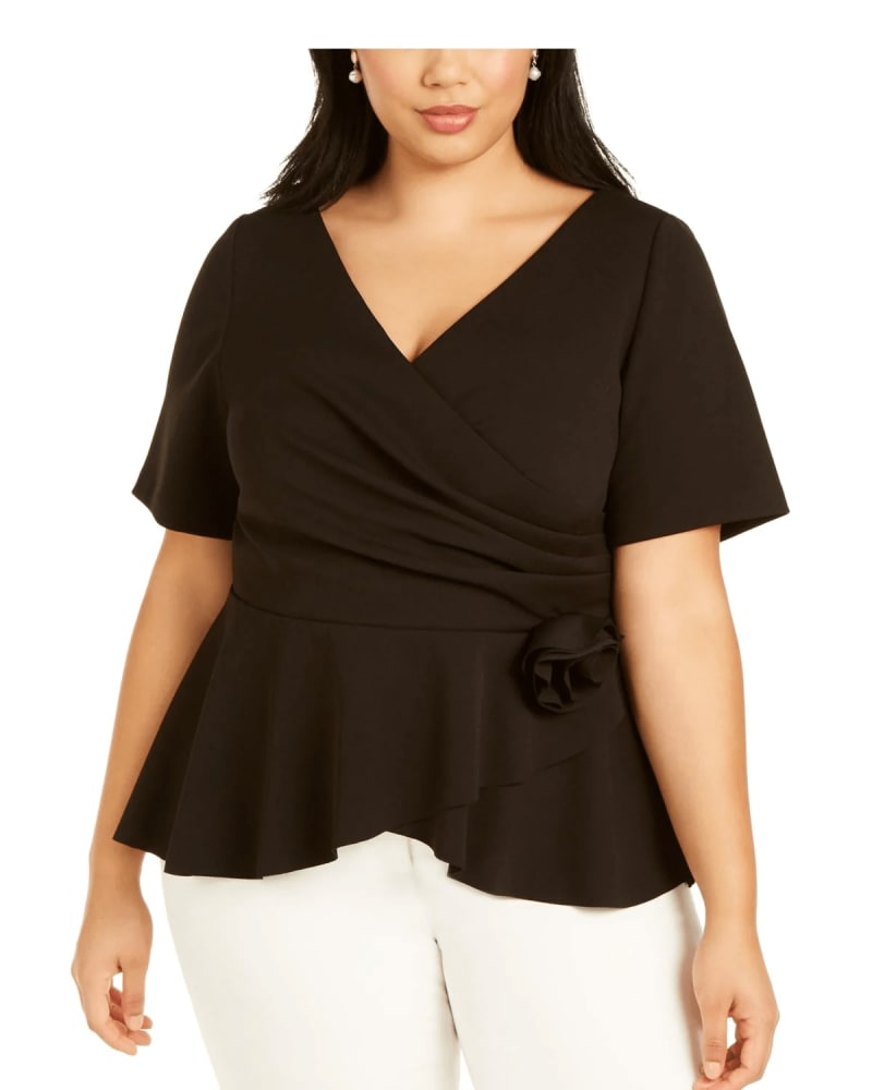 Front of a model wearing a size 12 Adrianna Papell Women's Plus Faux Wrap Rosette Wrap Top Black Size 12 Petite in Black by Adrianna Papell. | dia_product_style_image_id:311011